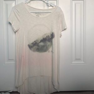 cream shirt with mountains in middle